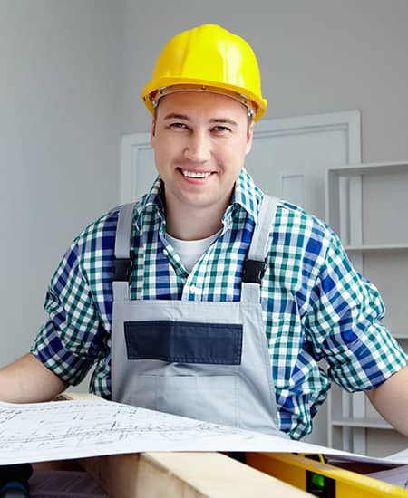 Tradesperson reviewing plans for a window and door fitting project